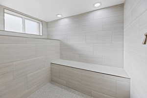 Bathroom with a tile shower and recessed lighting