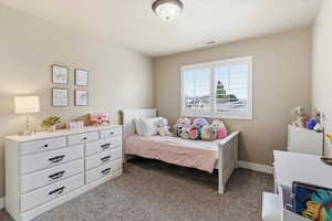 Carpeted bedroom with baseboards
