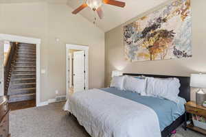Primary Bedroom featuring carpet, lofted ceiling, and ceiling fan