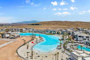 Community pool with a mountain view, a residential view, and a patio area