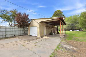 Garage featuring concrete driveway