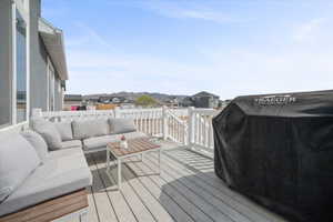 Wooden terrace featuring a residential view, area for grilling, and an outdoor living space
