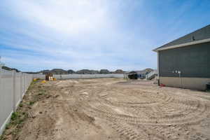 Fenced yard featuring a residential view. Side yard next to garage.