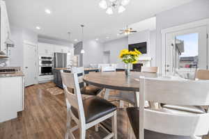 Dining room with ceiling fan, dark wood-style floors, and recessed lighting