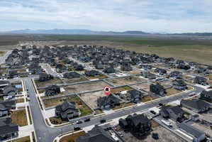 Aerial view of property's location with nearby suburban area and a mountainous background