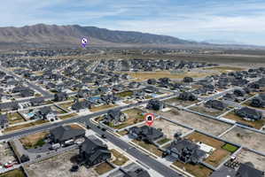 Aerial view of property's location featuring nearby suburban area and a mountain backdrop