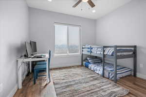 Bedroom with light wood finished floors, an office area, a ceiling fan, and recessed lighting