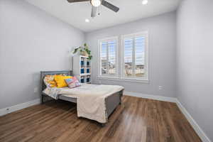 Bedroom with dark wood finished floors, a ceiling fan, and recessed lighting