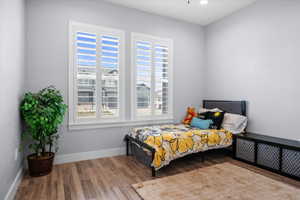 Bedroom featuring wood finished floors and baseboards
