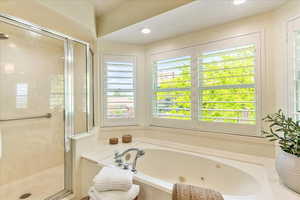 Full bath with a whirlpool tub, a stall shower, and recessed lighting