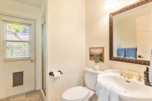 Full bathroom with toilet and a shower stall