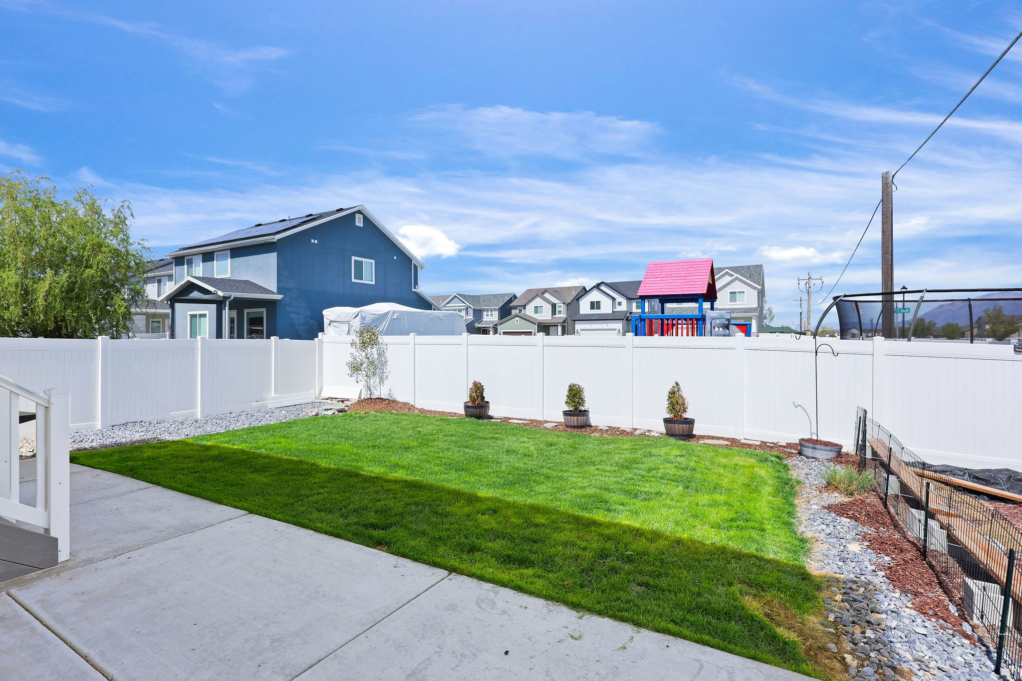 Fenced backyard featuring a residential view and a patio area