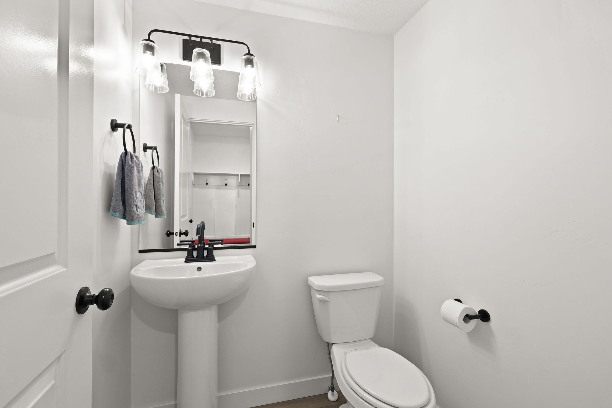 Half bathroom with toilet and baseboards