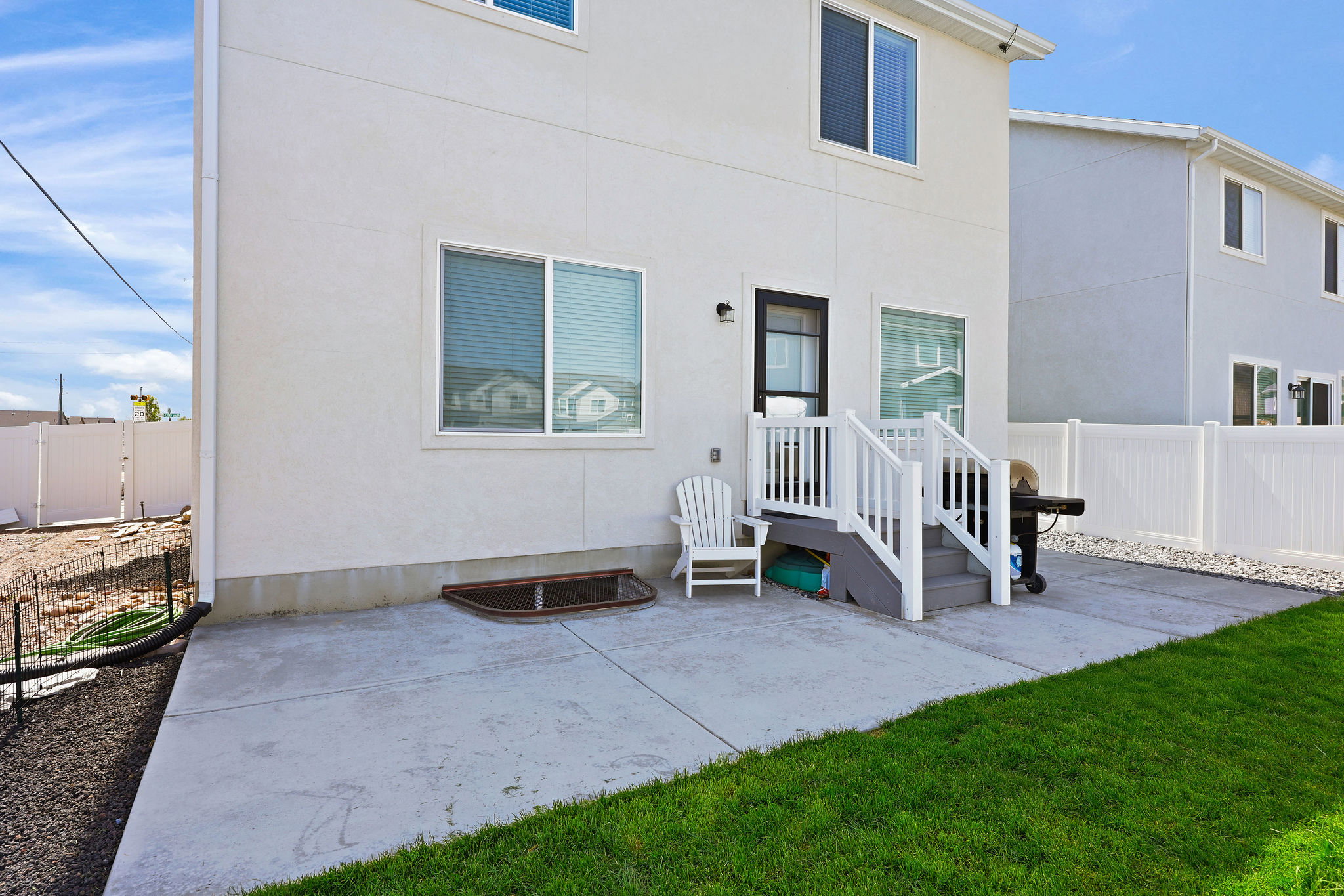 Back of house with a patio and stucco siding