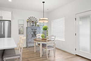 Dining room with light wood-style floors and baseboards