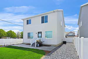 Rear view of house with a patio area and a fenced backyard