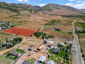 Aerial view of property's location featuring a mountain backdrop and rural landscape