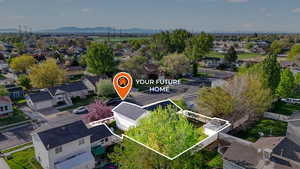 Aerial perspective of suburban area with property boundaries highlighted and a mountain backdrop