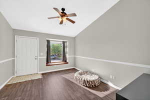 Foyer featuring dark wood finished floors, ceiling fan, and lofted ceiling