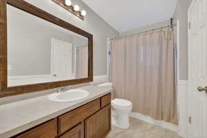 Full bathroom with vanity, a shower with curtain, and light marble finish flooring