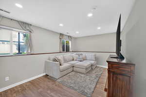 Living room featuring light wood finished floors and recessed lighting