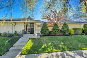 View of front of house with a front lawn and brick siding