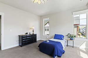 Bedroom with carpet and a textured ceiling