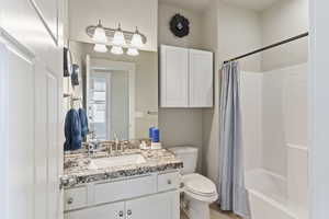 Bathroom with vanity and shower / bath combo with shower curtain