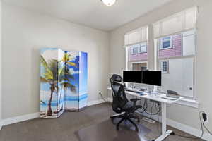 Office area featuring carpet floors and baseboards
