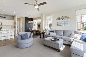 Living room with ceiling fan and recessed lighting