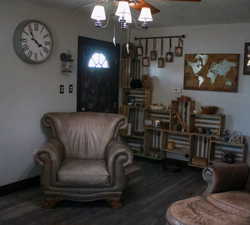 Living area featuring wood finished floors and a ceiling fan