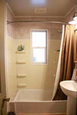 Full bathroom featuring shower / bath combo and a sink