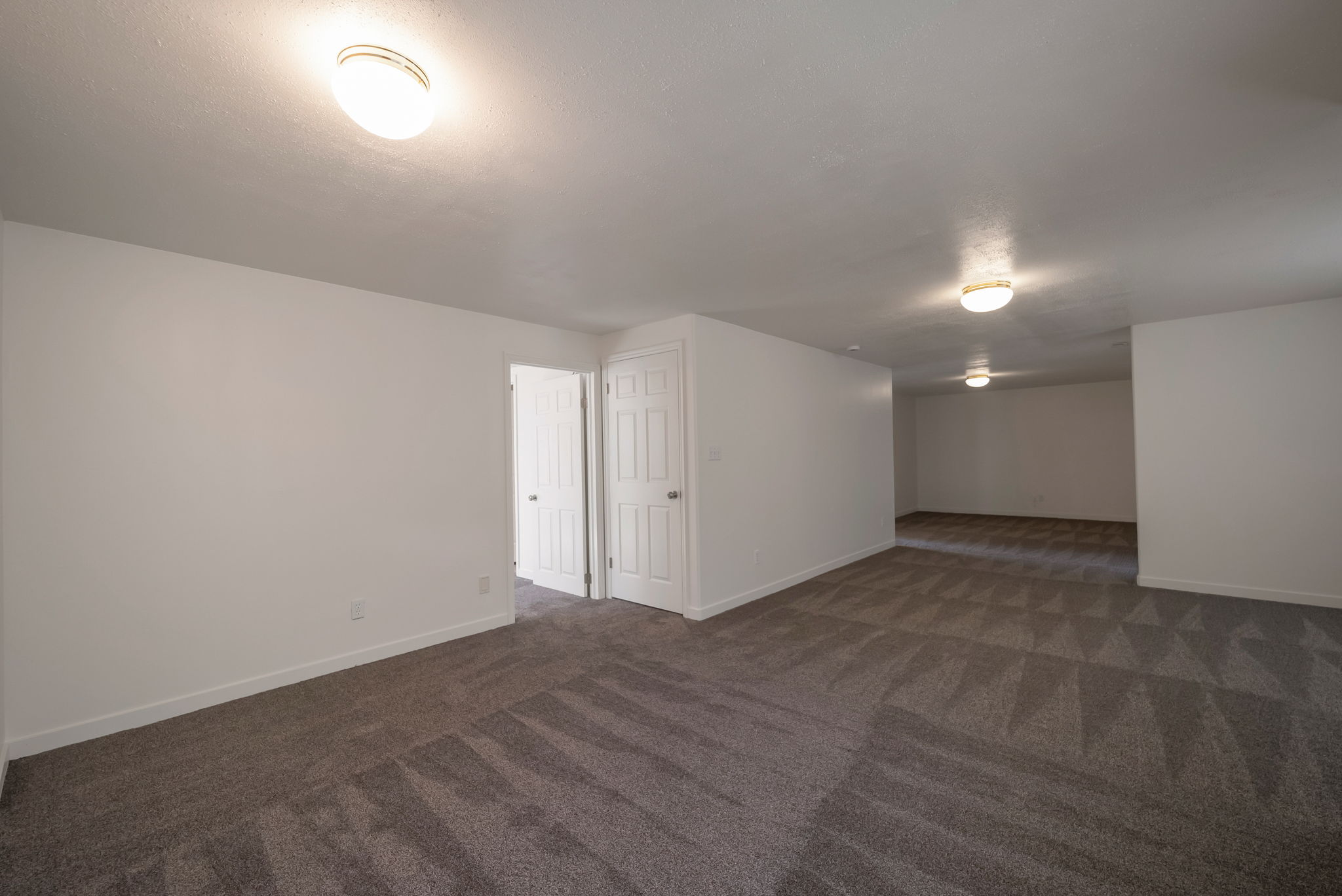 Bonus room featuring baseboards and dark colored carpet