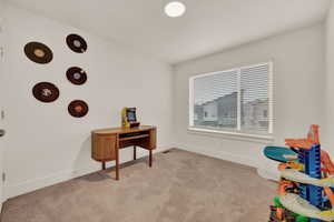 Rec room with baseboards and light colored carpet