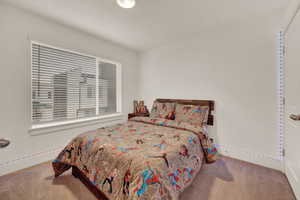 Carpeted bedroom featuring baseboards