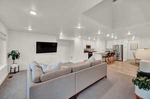 Living area featuring recessed lighting and light wood-style flooring