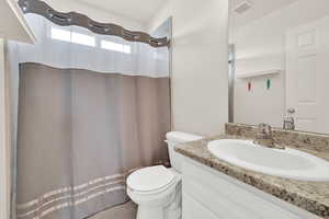 Full bath featuring a shower with curtain and vanity