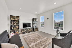 Living area featuring light carpet and recessed lighting