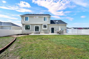 Rear view of property featuring a patio area, a fenced backyard, stucco siding, and entry steps