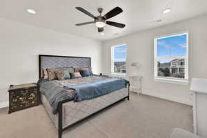 Bedroom featuring a ceiling fan, light carpet, and recessed lighting