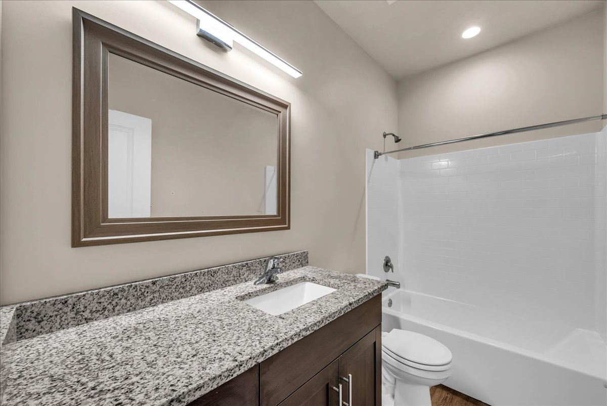 Bathroom featuring vanity, shower / washtub combination, and recessed lighting