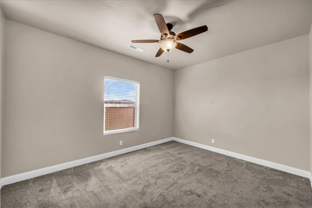 Spare room with light colored carpet and ceiling fan