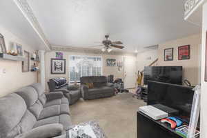 Living area featuring carpet floors and a ceiling fan