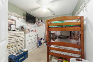 Bedroom with light carpet and ceiling fan