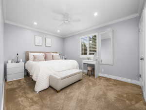 Carpeted bedroom with ornamental molding, recessed lighting, and ceiling fan