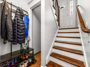 Stairway with baseboards and tile patterned flooring