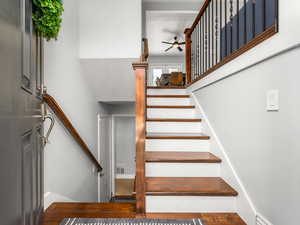 Entry to house. Stairs featuring a ceiling fan