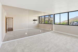Unfurnished bedroom featuring carpet flooring and a mountain view
