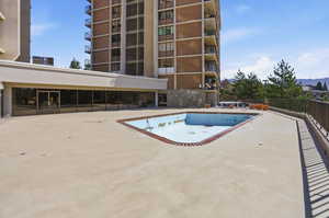 Community pool featuring a patio