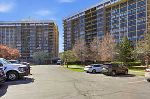 View of apartment building / complex with uncovered parking
